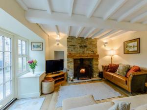a living room with a couch and a fireplace at 3 Bed in Leyburn oc-89746 in Spennithorne