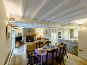 a living room with a table and chairs and a fireplace at 3 Bed in Leyburn oc-89746 in Spennithorne