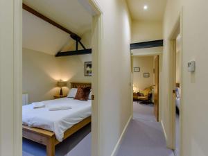 a bedroom with a bed and a room with a hallway at 3 Bed in Leyburn oc-89746 in Spennithorne