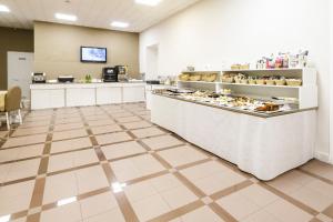 a bakery with a counter with food on it at Hotel Santa Marta in Pozzuoli