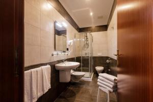 a bathroom with a toilet and a sink and a shower at Hotel Santa Marta in Pozzuoli +52 photos