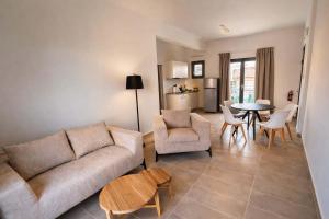 a living room with a couch and a table at CONSTA Luxury Apartments in Paralio Astros