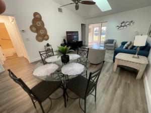 a living room with a glass table and chairs at Perfect lodging in Lake Placid in Lake Placid