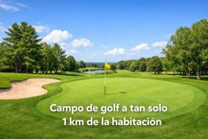 a golf course with a yellow flag on the green at Isa Rooms Sarria in Sarria