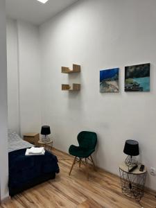 a bedroom with a bed and two chairs at Noclegi Korzybie in Korzybie