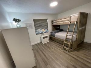 a bedroom with two bunk beds and a ladder at Perfect lodging in Lake Placid in Lake Placid