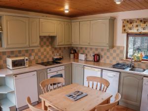 a kitchen with a wooden table and a table and chairs at Shires Rest in Buxton
