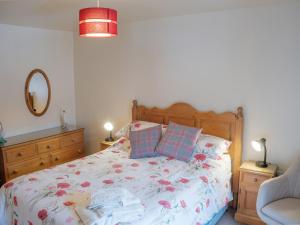 a bedroom with a bed and a chair at Shires Rest in Buxton
