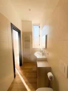 a bathroom with a sink and a toilet and a window at Le Tre Lune Rooms in Matera +27 photos