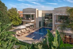 an exterior view of a house with a swimming pool at Ela Excellence Resort Belek in Belek