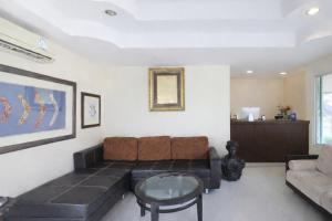 a living room with a couch and a table at The Room Suphanburi in Ban Nong Chaeng
