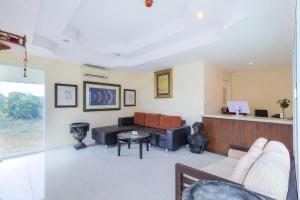 a living room with a couch and a table at The Room Suphanburi in Ban Nong Chaeng +31 photos