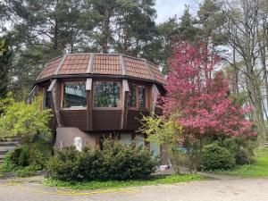 a small house with a roof on top of it at Art space Bundulis in Saulkrasti