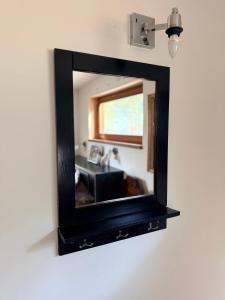 a mirror hanging on a wall in a living room at Art space Bundulis in Saulkrasti +48 photos