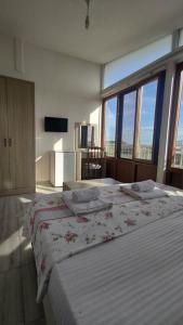 a bedroom with two beds and a large window at Midis Park Otel in Şarköy
