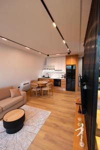 a living room with a couch and a table at Lakeside Villas & Jacuzzi Suites in Shirokë