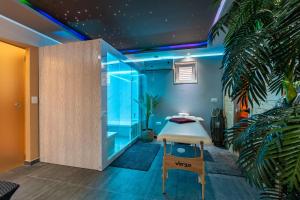 a room with a bed in a room with blue lights at Apartments Tomo in Sukošan
