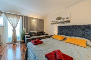 a bedroom with a large bed and a couch at Apartments Tomo in Sukošan +95 photos