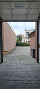 an empty courtyard in a building with a wall at Penzion Na Dlouhé in Uherské Hradiště