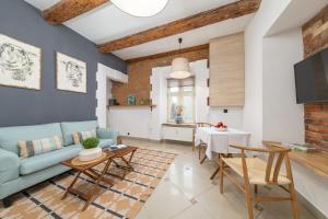 a living room with a blue couch and a table at PropertiesForYou in Bielsko-Biała
