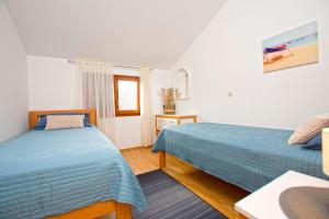 a bedroom with two beds and a window at Apartment Tina in Obrovac