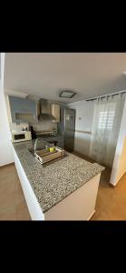 a kitchen with a granite counter top in a room at Casa Enrique in Alicante