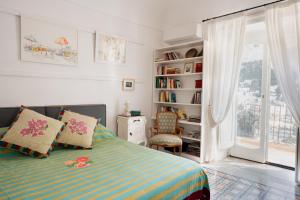a bedroom with a bed and a book shelf at Casa Sam Positano in Positano