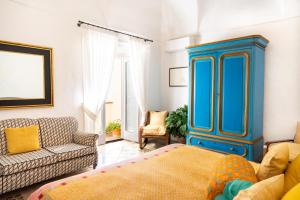 a living room with a blue cabinet and a couch at Casa Sam Positano in Positano