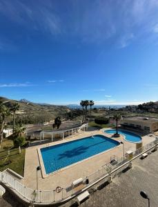 a large swimming pool next to a building at Casa Enrique in Alicante