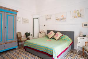 a bedroom with a bed and a blue cabinet at Casa Sam Positano in Positano +40 photos