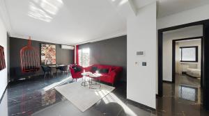 a living room with a red couch and a table at Seven Floors in Tunis +242 photos