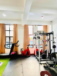 a gym with bikes and tread machines in a room at Sumni Hotel in Nkoanrua