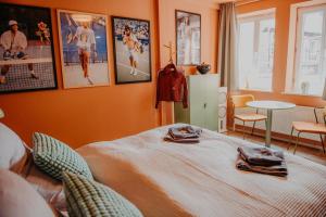 a bedroom with a bed and pictures on the wall at sleepArt match point in Celle