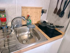 a kitchen counter with a sink in a kitchen at Garden Guesthouse, Sleep4, Private Entrance, Parking, Wifi, AirCon, Derby City in Derby +54 photos