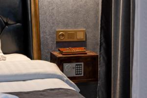 a bedroom with a bed and a radio on a night stand at HIDDEN BANK: Digger's Dream in Plovdiv