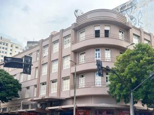 a large pink building with a round top at B Hotel 888 hotéis - Próximo a Rodoviária e Praça Sete in Belo Horizonte