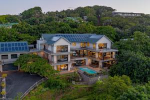 an aerial view of a house with a solar roof at Octopus Room in Ballito