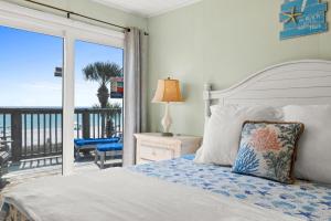 a bedroom with a bed and a view of the ocean at Sunny Beach by Book That Condo in Panama City Beach +138 photos