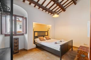 a bedroom with a large bed in a room at Casa con patio, piedra y luz natural in Sant Pere de Ribes