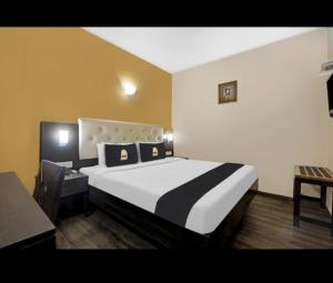 a bedroom with a large bed in a room at Hotel The Pal Palace in Nagpur