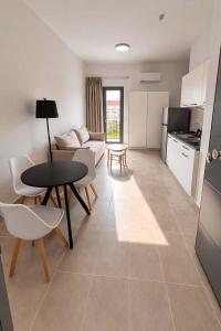 a kitchen and living room with a table and chairs at CONSTA Luxury Apartments in Paralio Astros +9 photos