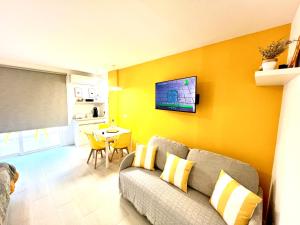 a living room with a couch and a table at Modern Studio with Pool & Terrace Playa de las Américas, Tenerife in Playa de las Americas