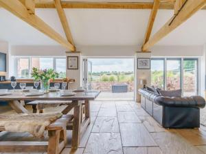 a dining room with a wooden table and leather chairs at 3 Bed in Malton oc-75899 in Amotherby