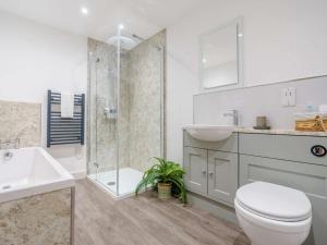 a bathroom with a toilet and a sink and a shower at 3 Bed in Malton oc-75899 in Amotherby +15 photos