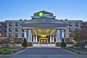 a large building with a clock on top of it at Holiday Inn Express Hotel & Suites Anderson by IHG in Anderson