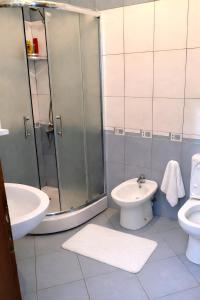 a bathroom with a shower and a toilet and a sink at EUREKA in Vlorë