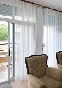 a living room with a couch and a window at EUREKA in Vlorë