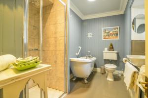 a bathroom with a shower and a toilet and a sink at The Quay House in Clifden