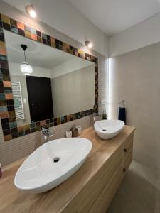 a bathroom with two sinks and a large mirror at Thermal Forest Apartment in Kiskunhalas +61 photos