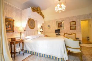 a bedroom with a white bed and a chair at The Quay House in Clifden